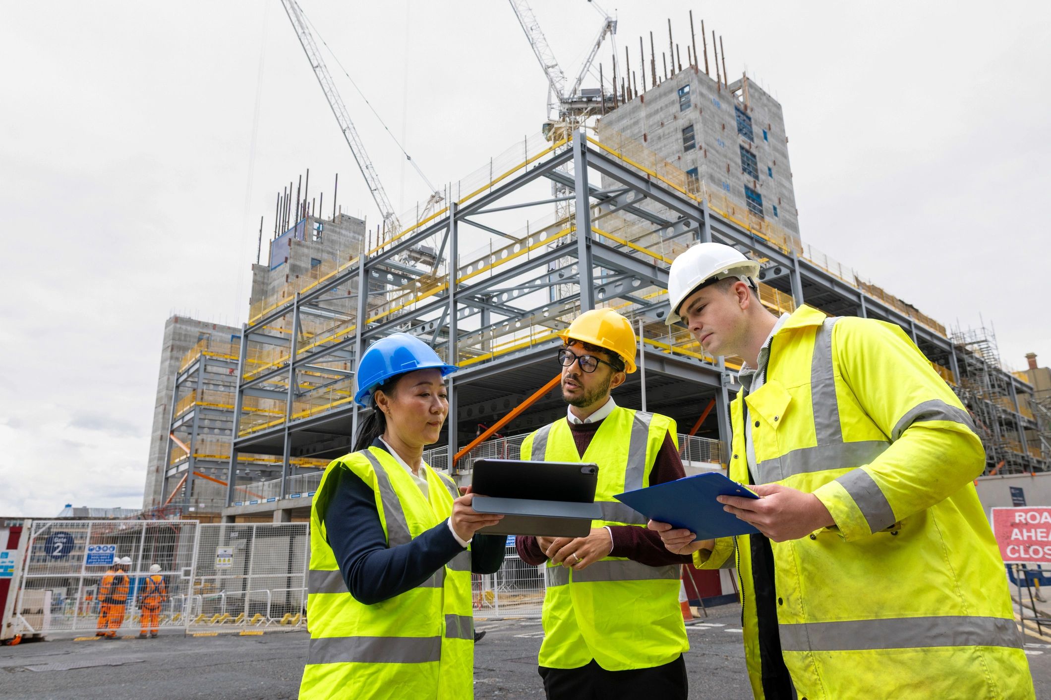 Construction team reviewing development plans outdoors